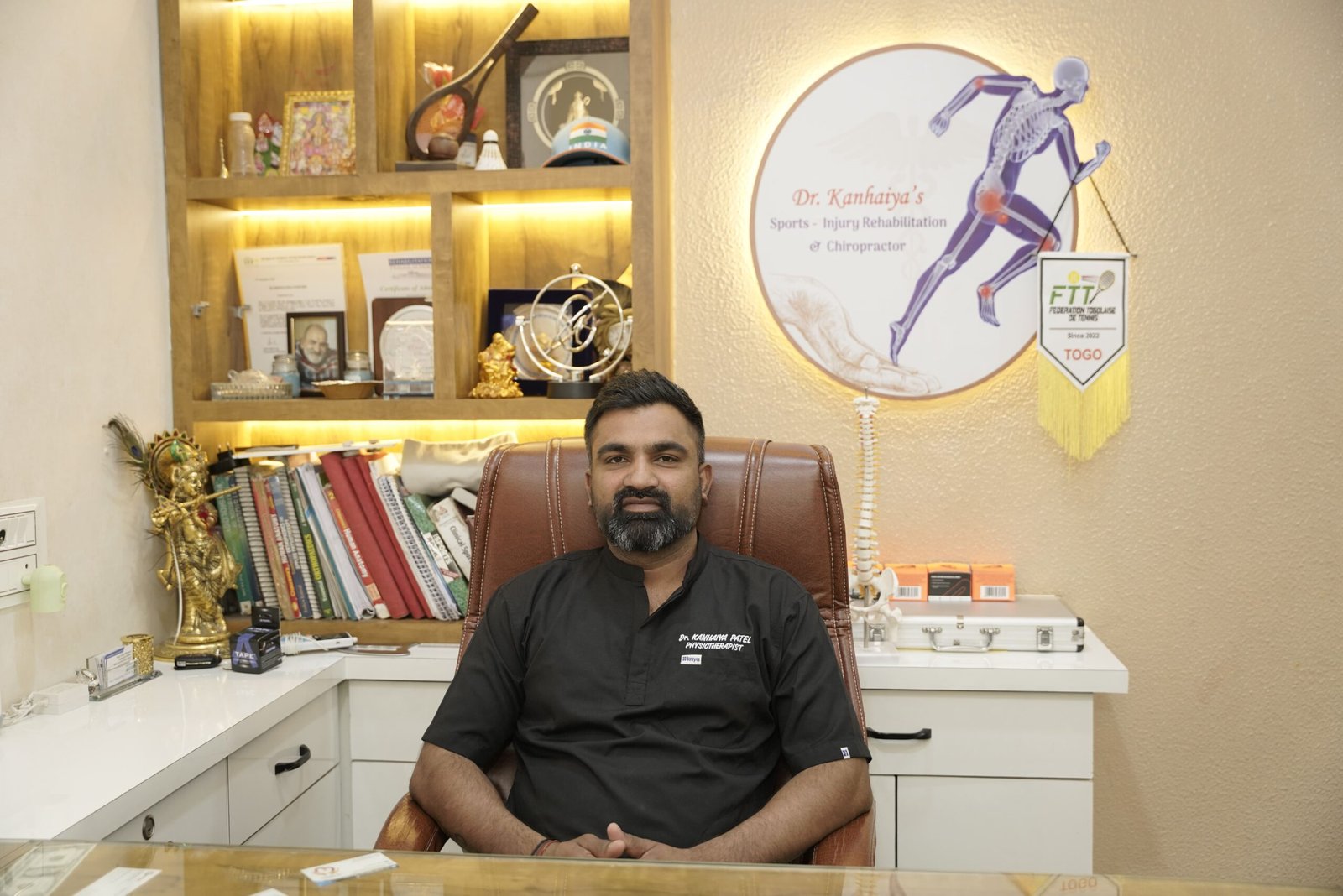 Dr. Kanhaiya Patel Sports Physiotherapist in Indore sitting in his clinic office