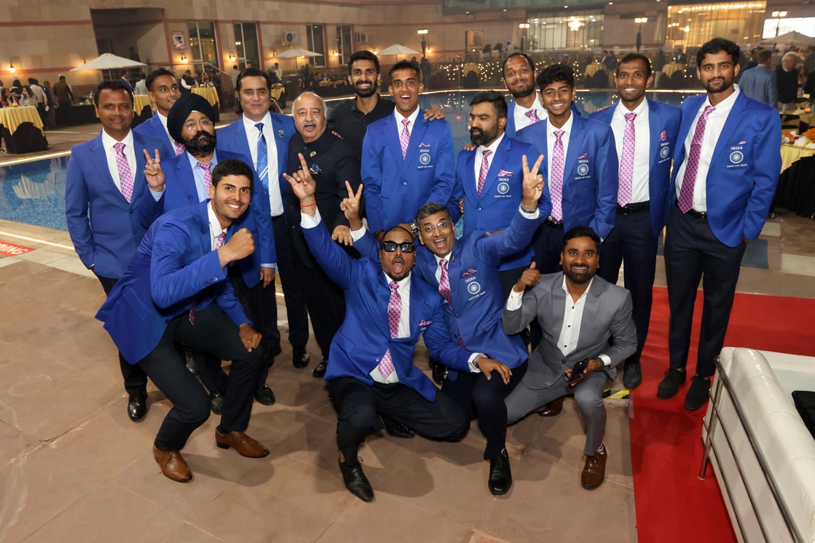 Sports physiotherapy team with professional athletes celebrating success at an event